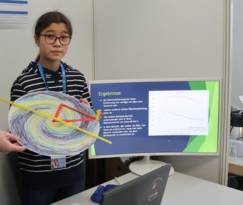 Catharina Hock with a model galaxy at the regional Nordbaden science fair. Catharina Hock with a model galaxy at the regional Nordbaden science fair.