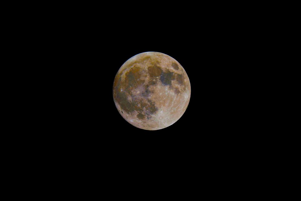 Colour-enhanced close-up of the full Moon with different areas in blue and orange