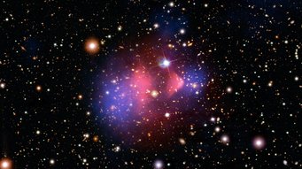 The Bullet Cluster: Hubble image of a galaxy cluster overlaid with two false-color images in pink and blue, marking a concentration in the center with a wedge-shaped compression and two separate regions outside The Bullet Cluster: Hubble image of a galaxy cluster overlaid with two false-color images in pink and blue, marking a concentration in the center with a wedge-shaped compression and two separate regions outside